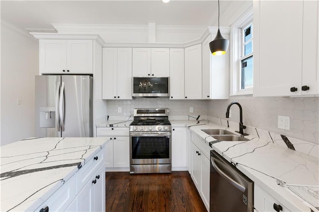 1919 N Prieur St, New Orleans, LA 70116 - kitchen featuring appliances with stainless steel finishes, a sink, white cabinetry, and crown molding