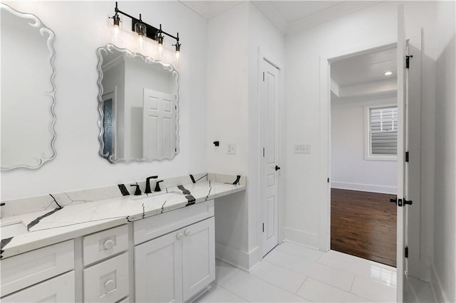 1919 N Prieur St, New Orleans, LA 70116 - bathroom featuring baseboards, crown molding, tile patterned floors, and vanity