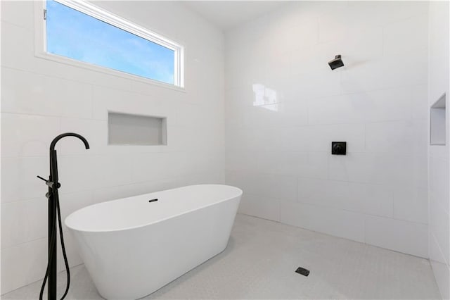 1919 N Prieur St, New Orleans, LA 70116 - bathroom featuring a freestanding tub, tile walls, and tiled shower