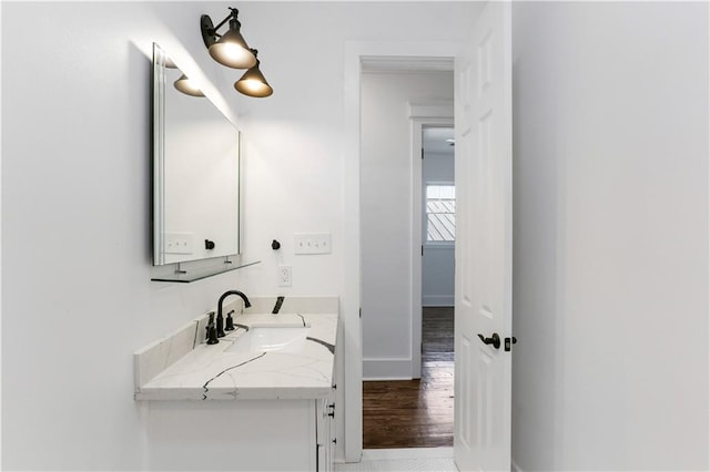 1919 N Prieur St, New Orleans, LA 70116 - bathroom with wood finished floors, baseboards, and vanity
