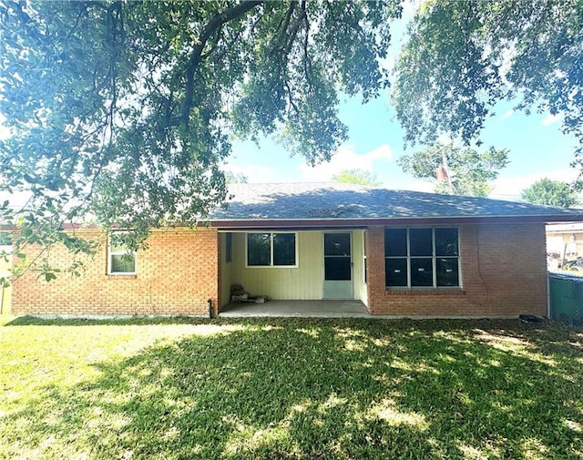 134B First St, Boutte, LA 70039 - back of property with a yard, brick siding, and a patio area