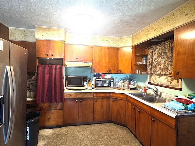 134B First St, Boutte, LA 70039 - kitchen with stainless steel appliances, a sink, a textured ceiling, open shelves, and light countertops