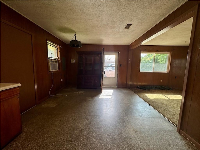 134B First St, Boutte, LA 70039 - entryway with tile patterned floors, wooden walls, a textured ceiling, a chandelier, and cooling unit