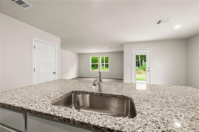24231 Gadwall Ave, Ponchatoula, LA 70454 - kitchen with a sink, light stone counters, open floor plan, and recessed lighting