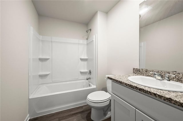 24231 Gadwall Ave, Ponchatoula, LA 70454 - bathroom featuring wood finished floors, toilet, vanity, and bathtub / shower combination