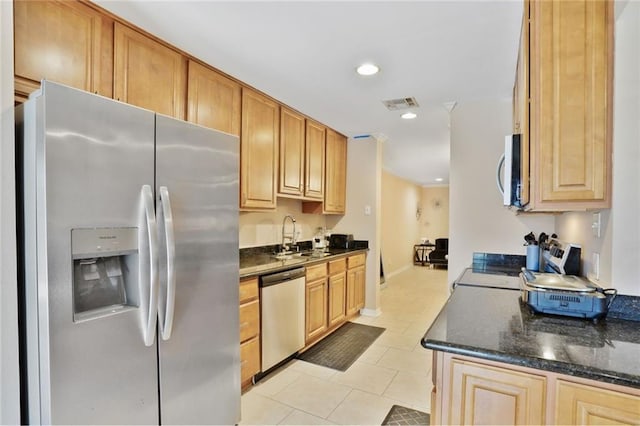 107 10th St Unit 107, New Orleans, LA 70124 - kitchen with stainless steel appliances, a sink, light tile patterned flooring, recessed lighting, and dark stone counters