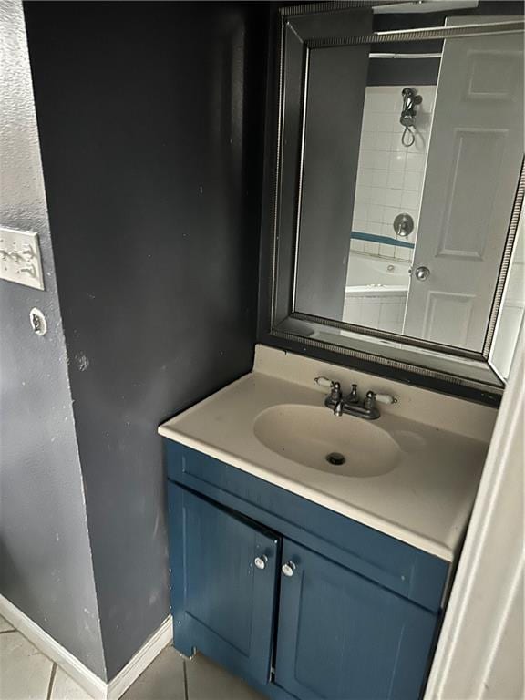 bathroom featuring vanity, tile patterned floors, a tub to relax in, and a shower