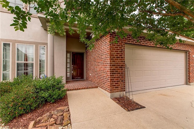 17181 Bridle Path, Hammond, LA 70403 - entrance to property with brick siding, driveway, a garage, and stucco siding