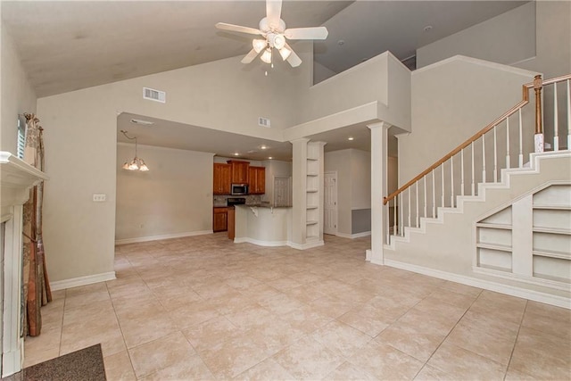 17181 Bridle Path, Hammond, LA 70403 - unfurnished living room with a ceiling fan, high vaulted ceiling, built in shelves, ornate columns, and light tile patterned floors
