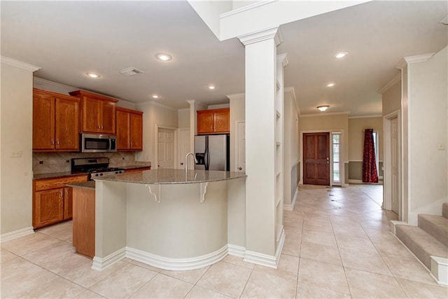 17181 Bridle Path, Hammond, LA 70403 - kitchen with stainless steel appliances, crown molding, brown cabinets, decorative backsplash, and a breakfast bar