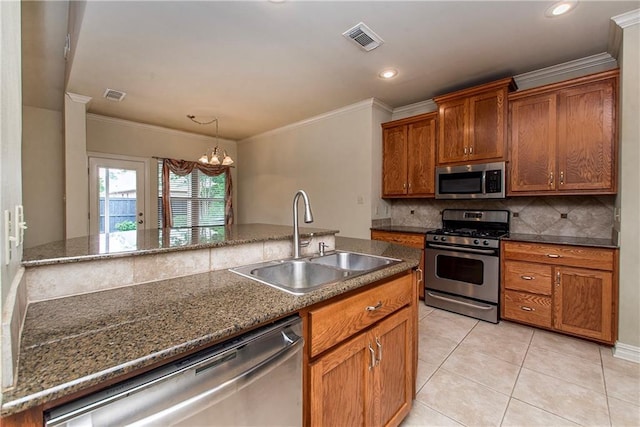 17181 Bridle Path, Hammond, LA 70403 - kitchen with appliances with stainless steel finishes, a sink, tasteful backsplash, brown cabinets, and ornamental molding