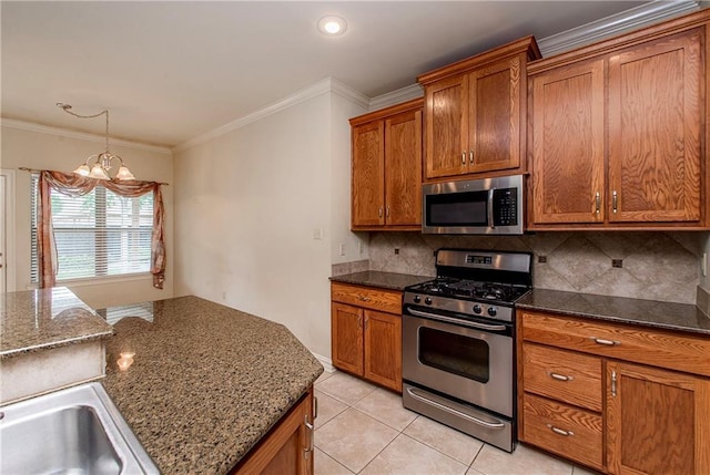 17181 Bridle Path, Hammond, LA 70403 - kitchen featuring appliances with stainless steel finishes, a chandelier, brown cabinets, backsplash, and ornamental molding