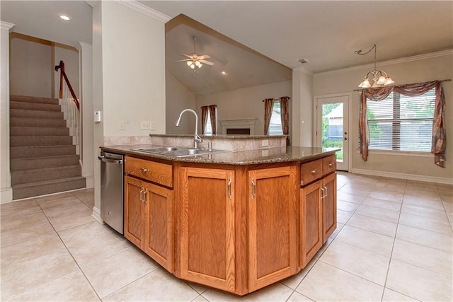 17181 Bridle Path, Hammond, LA 70403 - kitchen with a sink, stainless steel dishwasher, light tile patterned floors, dark stone countertops, and brown cabinetry