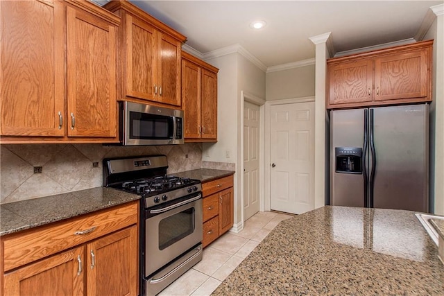 17181 Bridle Path, Hammond, LA 70403 - kitchen with stainless steel appliances, ornamental molding, light tile patterned flooring, tasteful backsplash, and brown cabinets