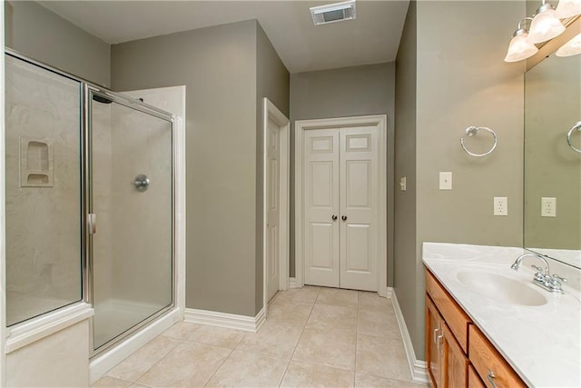 17181 Bridle Path, Hammond, LA 70403 - bathroom featuring a stall shower, baseboards, tile patterned flooring, a chandelier, and vanity