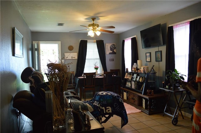 4133 Pauger St, New Orleans, LA 70122 - tiled living area with ceiling fan and healthy amount of natural light