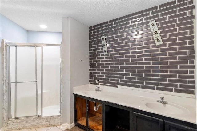 70 Hyacinth Dr, Covington, LA 70433 - full bath with a stall shower, a textured ceiling, a sink, and decorative backsplash