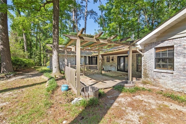 70 Hyacinth Dr, Covington, LA 70433 - back of property with a pergola, brick siding, and a patio area