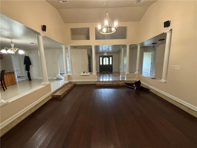 45246 Morris Rd, Hammond, LA 70401 - spare room with decorative columns, a chandelier, wood finished floors, baseboards, and high vaulted ceiling