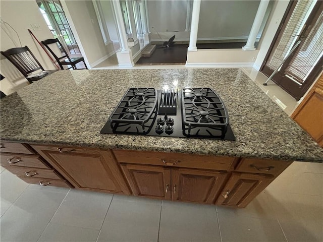 45246 Morris Rd, Hammond, LA 70401 - kitchen view of ornate columns, black gas cooktop, brown cabinets, and dark stone countertops