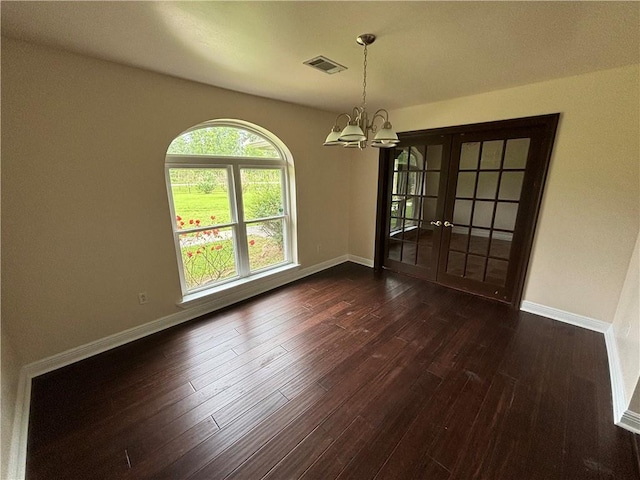45246 Morris Rd, Hammond, LA 70401 - unfurnished dining area with a chandelier, dark wood finished floors, baseboards, and french doors