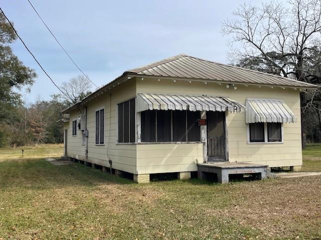41012 S Range Rd, Ponchatoula, LA 70454 - back of property featuring a lawn and metal roof