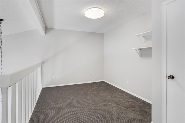 2912 Manhattan Blvd Unit 133, Harvey, LA 70058 - empty room with dark carpet, beam ceiling, a textured ceiling, and baseboards