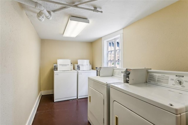 2615 S Carrollton Ave Unit I, New Orleans, LA 70118 - communal laundry room with washer and clothes dryer, baseboards, and a textured wall