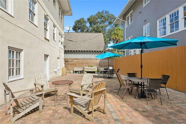 2615 S Carrollton Ave Unit I, New Orleans, LA 70118 - view of patio featuring outdoor dining space and a fenced backyard