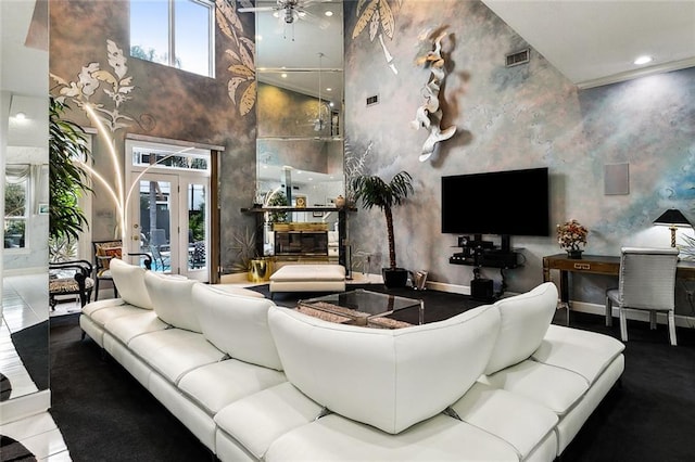 3805 3rd St, Metairie, LA 70002 - living area featuring a towering ceiling, a ceiling fan, and baseboards