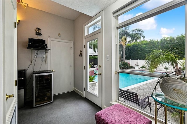 3805 3rd St, Metairie, LA 70002 - doorway to outside featuring beverage cooler, carpet flooring, and a dry bar