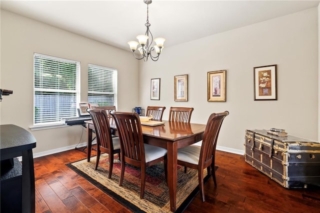 dining room featuring a chandelier, hardwood / wood-style floors, and baseboards