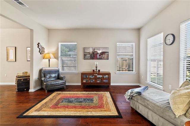 living area with wood-type flooring, plenty of natural light, and baseboards