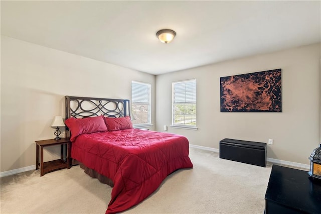 bedroom featuring carpet and baseboards