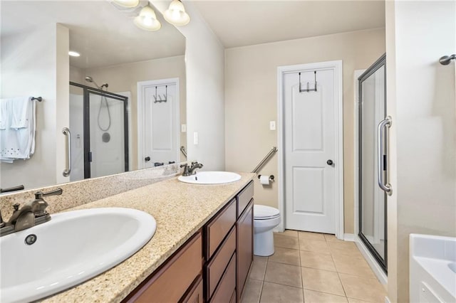 bathroom with a stall shower, tile patterned flooring, double vanity, and toilet