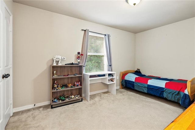 bedroom with carpet flooring and baseboards