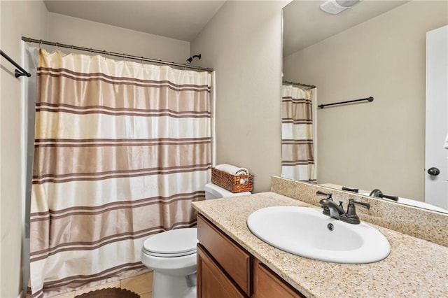 full bath featuring toilet, vanity, tile patterned floors, and curtained shower