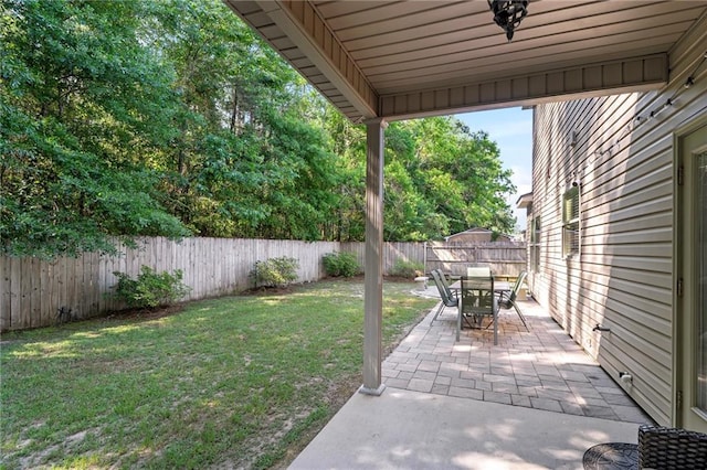 view of yard featuring a patio and outdoor dining area