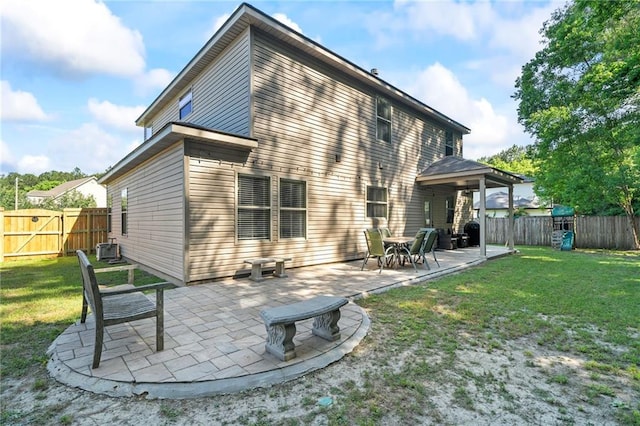 rear view of house with a patio area and a gate