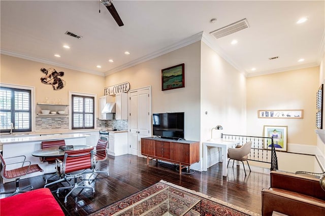 living area featuring dark wood-type flooring, ornamental molding, recessed lighting, and ceiling fan