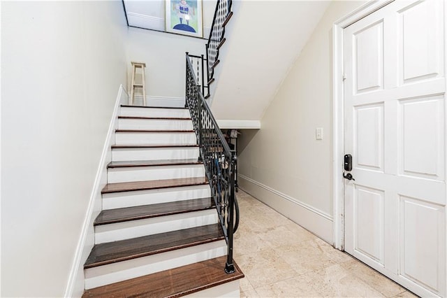stairway featuring baseboards