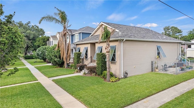 5805 Argonne Blvd, New Orleans, LA 70124 - view of home's exterior featuring a yard, a patio area, and a shingled roof