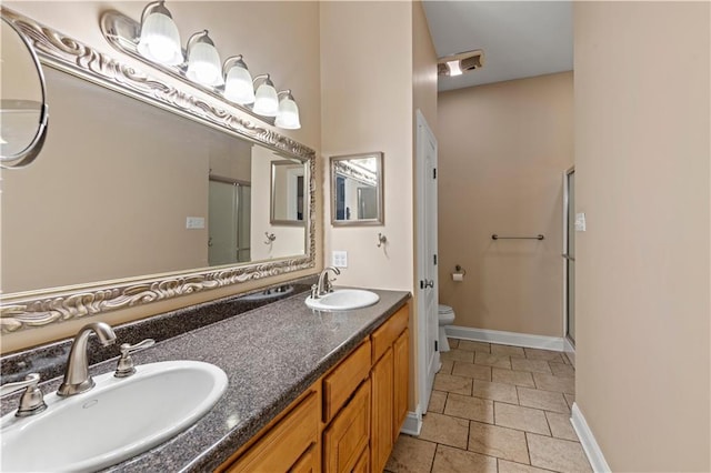 5805 Argonne Blvd, New Orleans, LA 70124 - bathroom with a shower stall, toilet, double vanity, and baseboards