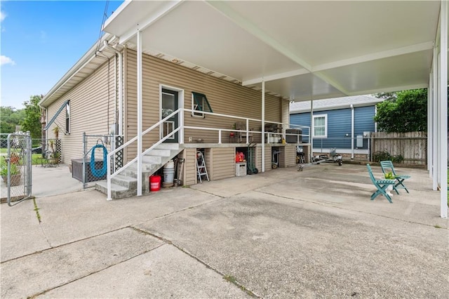 5805 Argonne Blvd, New Orleans, LA 70124 - view of property exterior with a carport, fence, a gate, and stairs
