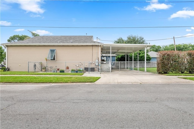 5805 Argonne Blvd, New Orleans, LA 70124 - view of side of property featuring concrete driveway, a gate, and an attached carport