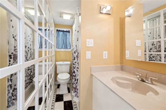 bathroom featuring toilet and vanity