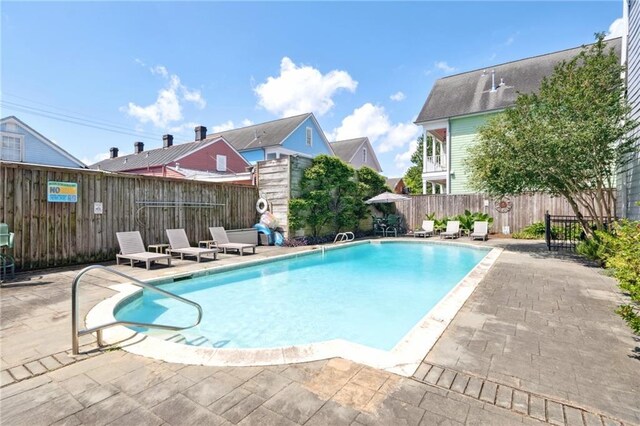 view of pool with a patio and a fenced backyard