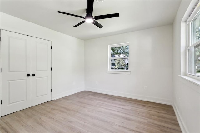 2004 Bluebird St, Slidell, LA 70460 - unfurnished bedroom featuring light wood-type flooring, a closet, baseboards, and ceiling fan