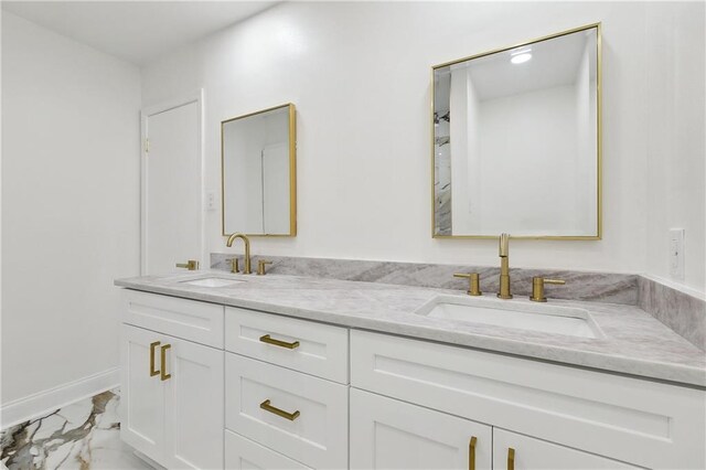 27 Yellowstone Dr, New Orleans, LA 70131 - full bathroom with marble look tile flooring, double vanity, and baseboards