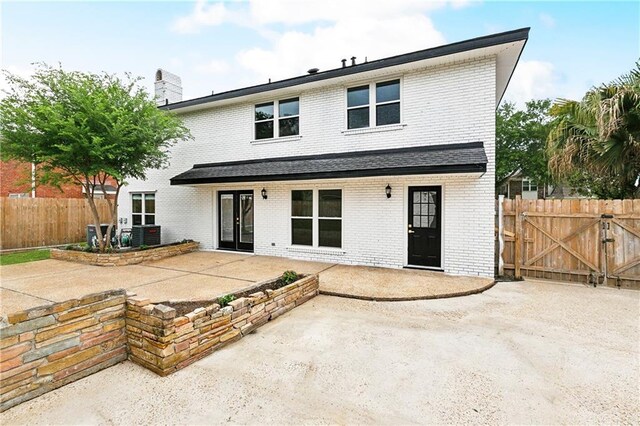 27 Yellowstone Dr, New Orleans, LA 70131 - rear view of house with brick siding, a patio area, fence, and a chimney